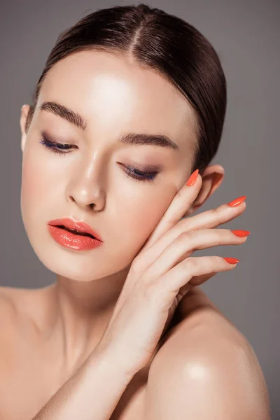 Beautiful fashionable girl touching face and posing isolated on grey — Stock Photo