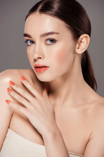 Beautiful stylish girl looking at camera and posing isolated on grey — Stock Photo