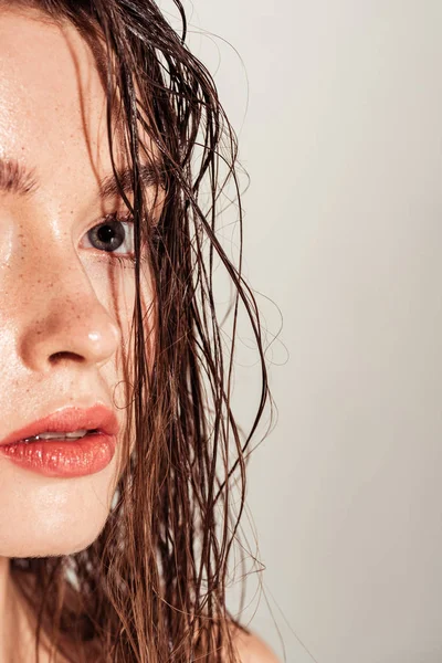 Beautiful sensual girl with coral lips and wet hair posing isolated on grey — Stock Photo