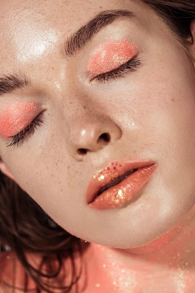 Close up of beautiful girl with coral glitter makeup and eyes closed — Stock Photo