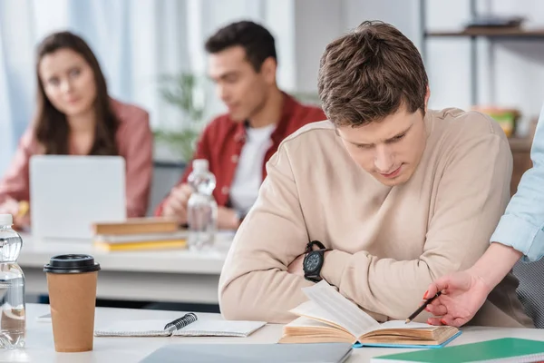 Partial view of woman with pencil explaining lesson to student — Stock Photo