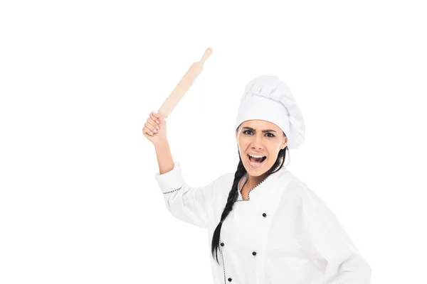 Angry chef in hat holding rolling pin and screaming isolated on white — Stock Photo
