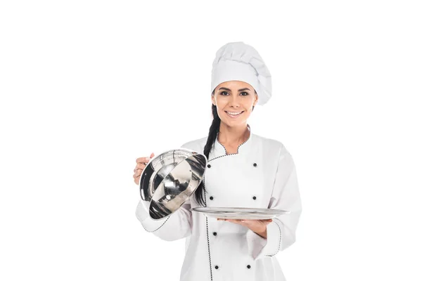 Chef in hat holding tray with cloche isolated on white — Stock Photo