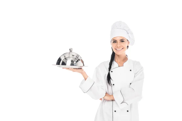 Chef in hat holding tray with cloche isolated on white — Stock Photo