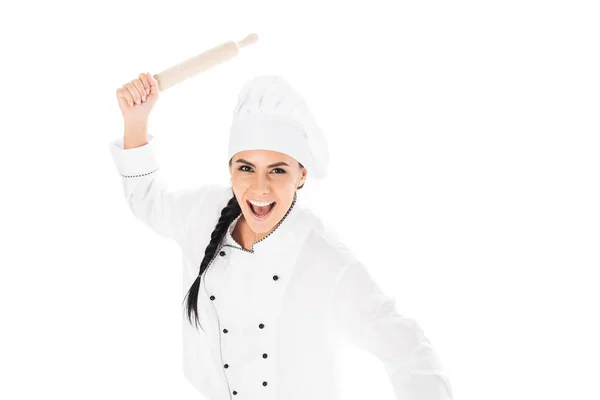 Aggressive chef in hat holding rolling pin and screaming isolated on white — Stock Photo