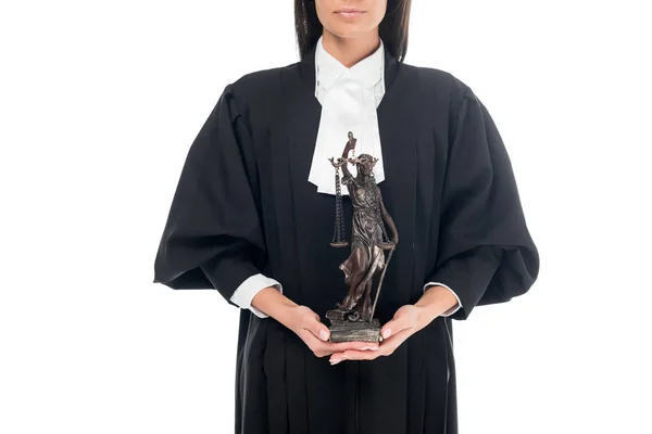 Vista parziale del giudice in veste giudiziaria che tiene themis statuetta isolata su bianco — Foto stock