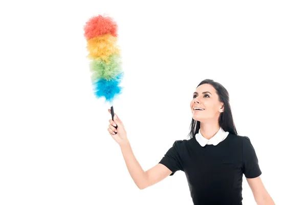 Brunette maid in uniform holding duster isolated on white — Stock Photo