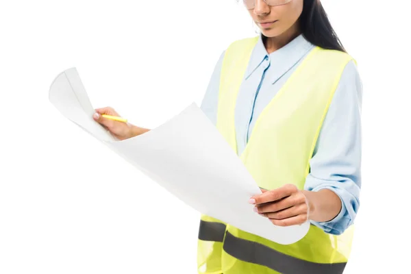 Cropped view of concentrated engineer in safety vest looking at blueprint isolated on white — Stock Photo