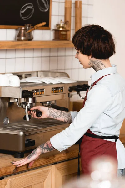 Selektiver Fokus des hübschen Barista, der Kaffee auf Espressomaschine zubereitet — Stockfoto