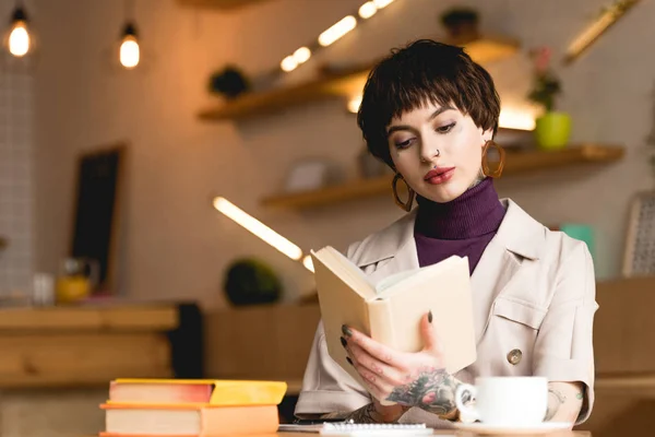 Atraente empresária leitura livro enquanto sentado no café — Fotografia de Stock