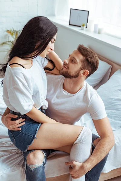 Handsome man hugging beautiful and brunette woman in t-shirt — Stock Photo