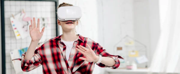 Panoramic shot of teenager in checkered shirt and vr headset — Stock Photo