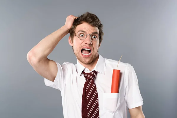 Scared businessman in glasses screaming with dynamite in pocket — Stock Photo