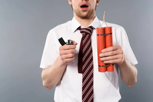 Cropped view of shocked businessman holding lighter and dynamite on grey background — Stock Photo