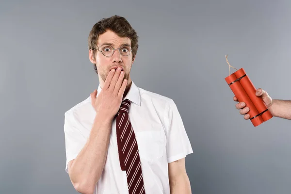 Frightened man holding hand on mouth while another holding dynamite — Stock Photo