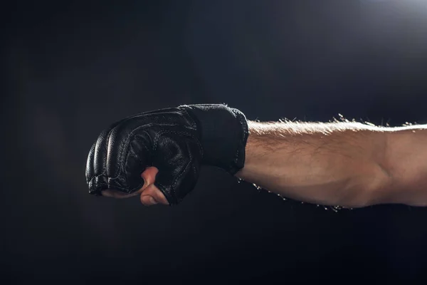 Vue recadrée du boxeur en gant de cuir sur fond noir — Photo de stock