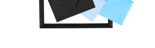 Panoramic shot of frame and envelopes isolated on white — Stock Photo