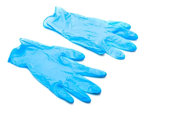 Dos guantes de goma azul aislados en superficie blanca - foto de stock