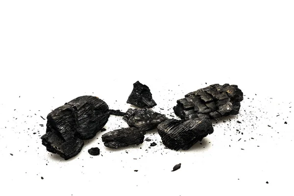 Black burnt firewood with ash on white surface — Stock Photo