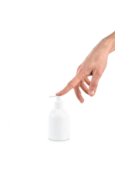 Partial view of man pushing spray on cream bottle isolated on white — Stock Photo