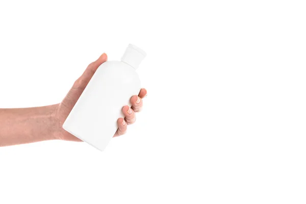 Cropped view of woman holding cosmetic bottle isolated on white — Stock Photo