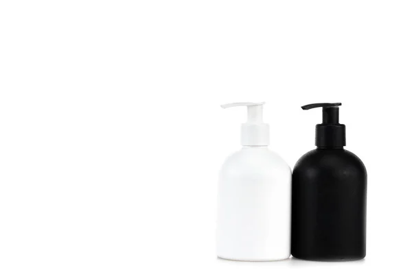 Flaconi spray cosmetici bianchi e neri isolati su bianco — Foto stock