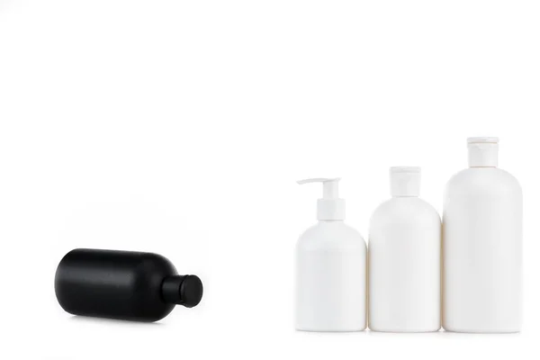 Black and white cosmetic bottles isolated on white — Stock Photo