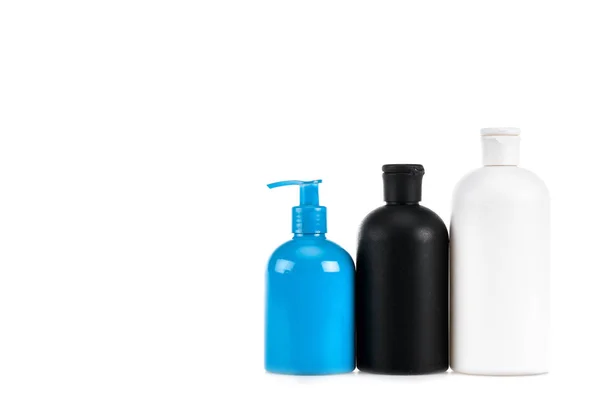 Three cosmetic bottles with spray isolated on white — Stock Photo