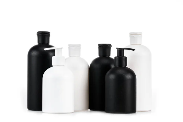 Black and white cosmetic bottles isolated on white — Stock Photo