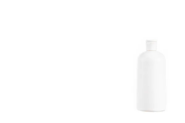 White cosmetic bottle with cap isolated on white — Stock Photo