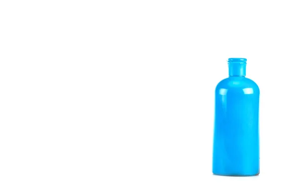 Blue cosmetic bottle with cap isolated on white — Stock Photo