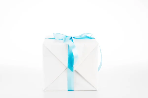 White gift box with blue ribbon on white — Stock Photo