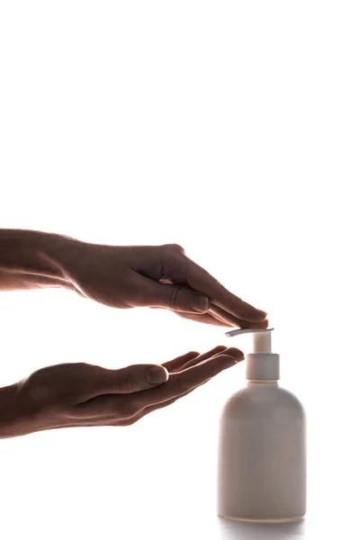 Partial view of woman using cosmetic spray bottle on white — Stock Photo