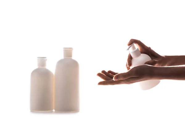 Partial view of woman applying hand cream on white — Stock Photo