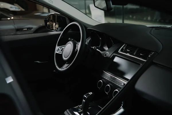 Black steering wheel near gear shift in luxury car — Stock Photo