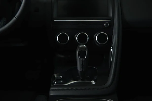 Modern black gear shift near buttons in luxury car — Stock Photo