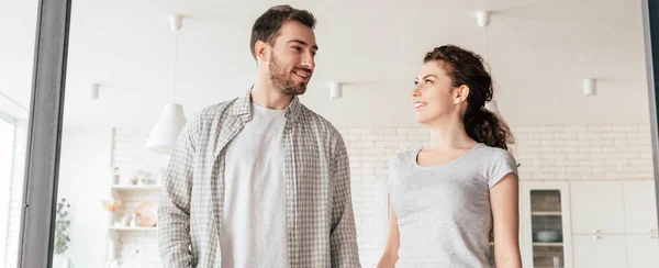 Panoramic shot of happy couple looking at each other with smile — Stock Photo