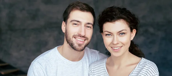 Panoramic shot of happy couple looking at camera with smile — Stock Photo