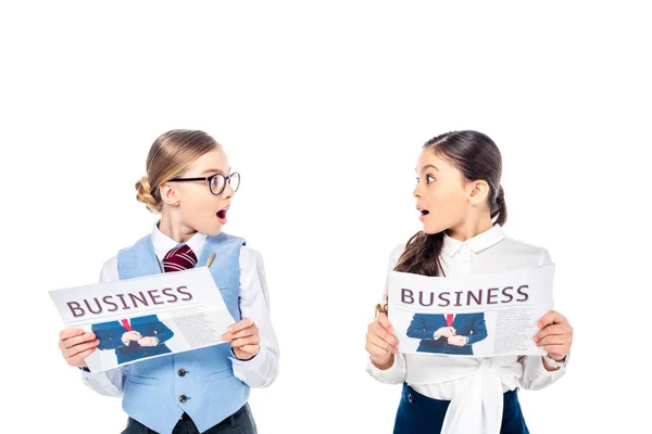 Surprised schoolgirls in formal wear with business newspapers looking at each other Isolated On White — Stock Photo