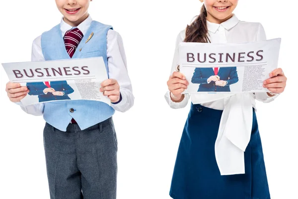 Abgeschnittene Ansicht von Schulmädchen in formeller Kleidung mit Wirtschaftszeitungen isoliert auf Weiß — Stockfoto