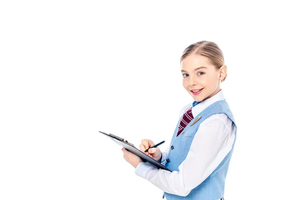 Adorable schoolgirl in formal wear writing in clipboard Isolated On White with copy space — Stock Photo