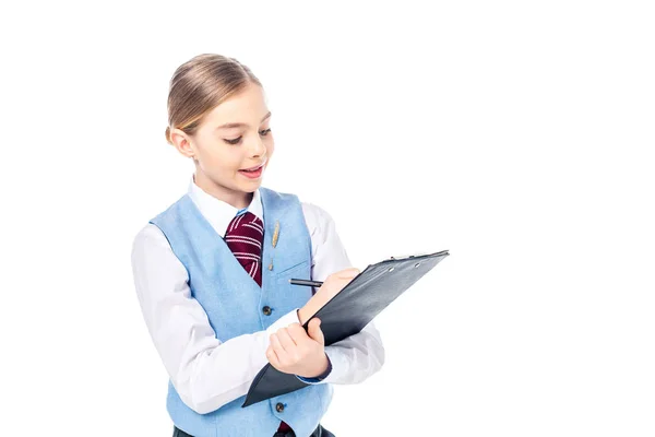 Adorable schoolgirl in formal wear writing in clipboard Isolated On White with copy space — Stock Photo
