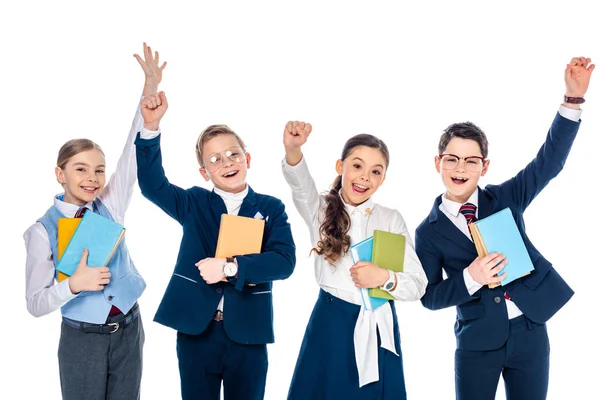Happy schoolchildren with outstretched hands holding books Isolated On White — Stock Photo