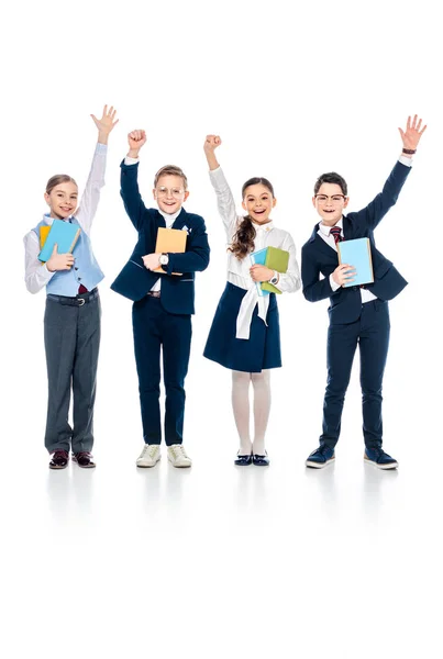Heureux écoliers avec les mains tendues tenant des livres sur blanc — Photo de stock