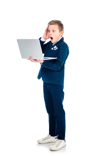 Shocked schoolboy in businessman suit using laptop On White — Stock Photo