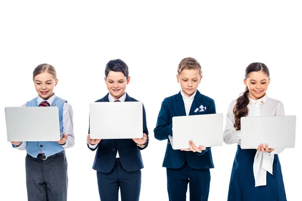 Escolares fingiendo ser empresarios que usan computadoras portátiles aisladas en blanco - foto de stock