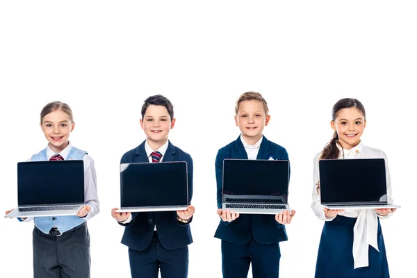 Schoolchildren pretending to be businesspeople holding laptops with blank screen Isolated On White — Stock Photo