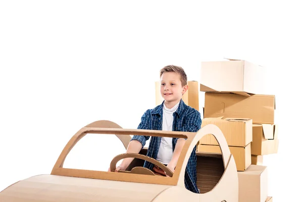 Adorable boy playing with cardboard car Isolated On White with copy space — Stock Photo