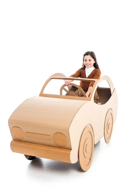Happy kid playing with cardboard car on white with copy space — Stock Photo