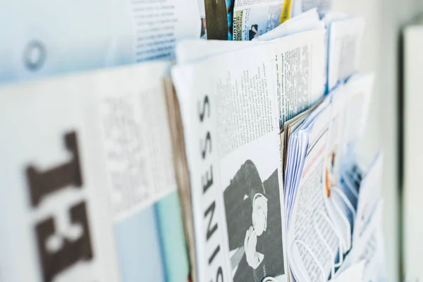 Selective focus of different print newspapers on stand — Stock Photo